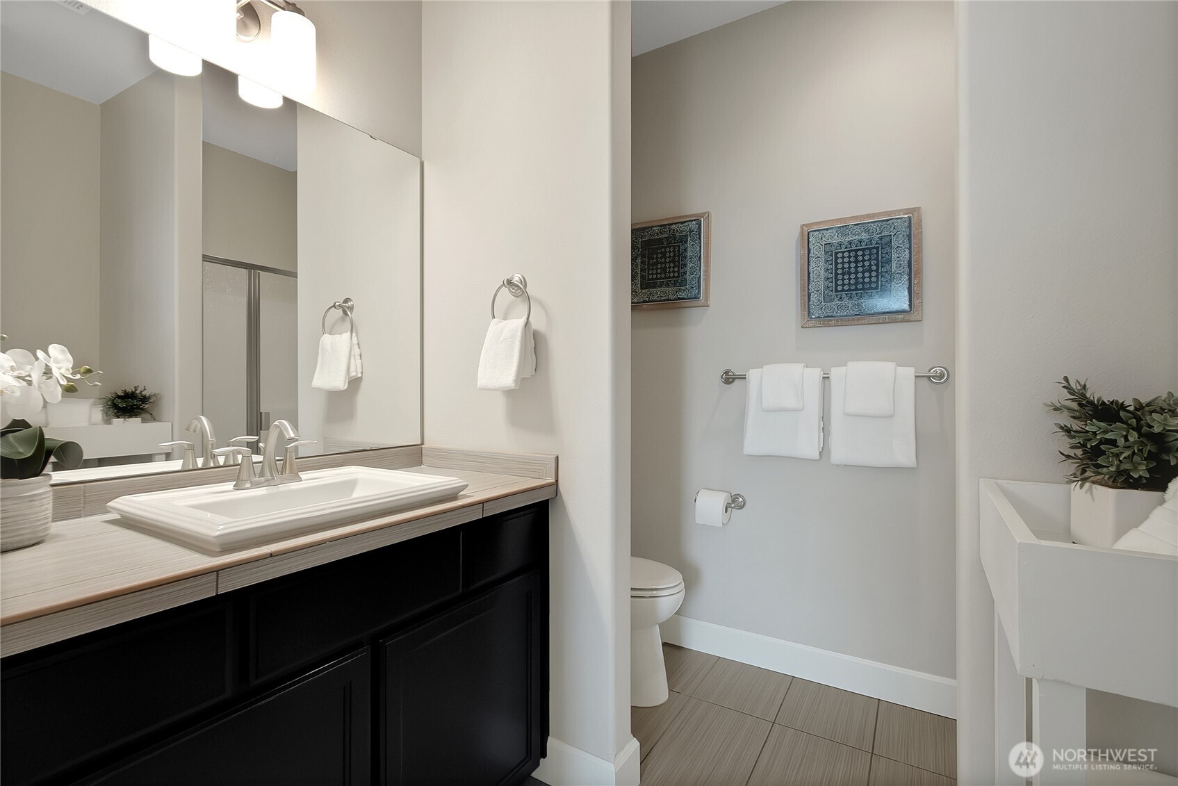 14925 Benton Loop Sumner, WA 98390 - Photo 19 of 40 a bathroom with a double vanity sink toilet and mirror