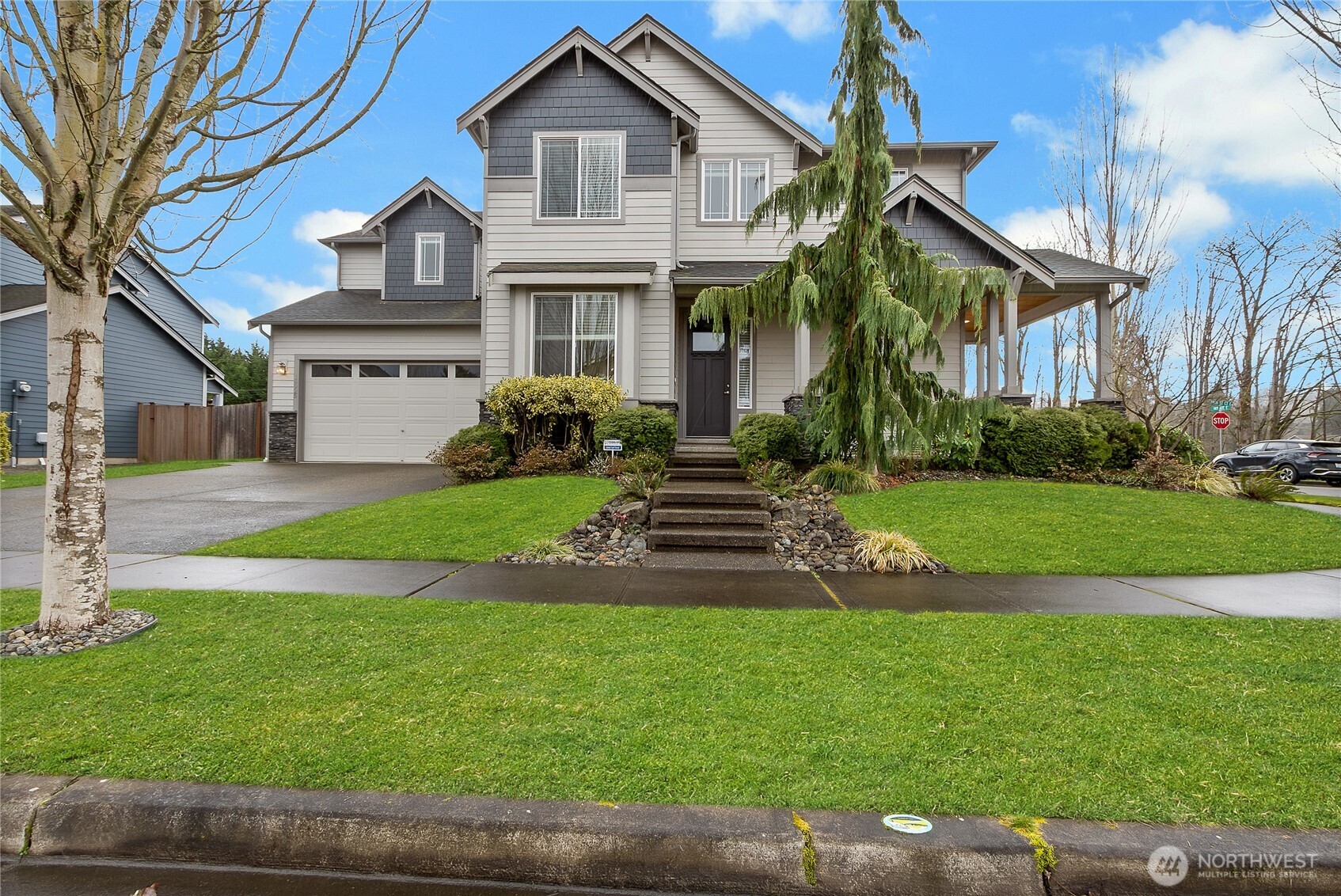 14925 Benton Loop Sumner, WA 98390 - Photo 2 of 40 a front view of a house with a yard and garage