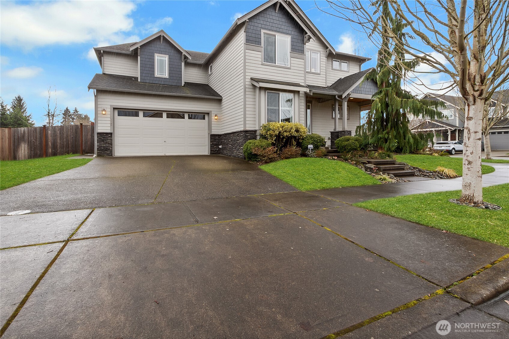 14925 Benton Loop Sumner, WA 98390 - Photo 3 of 40 a front view of a house with a yard and a garage