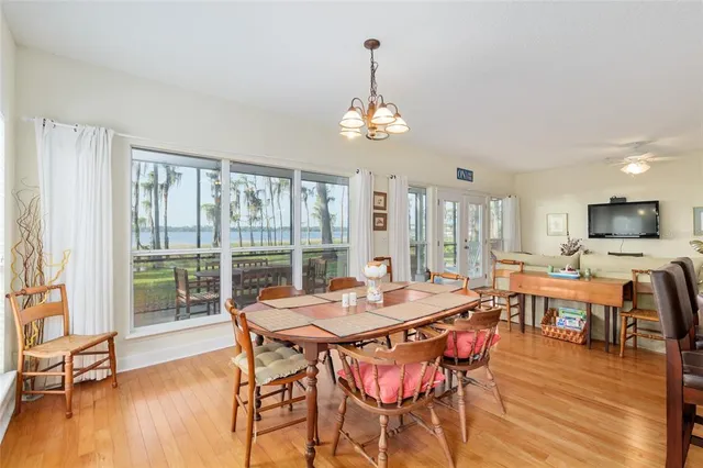 a kitchen with stainless steel appliances granite countertop a sink a stove and a wooden floors