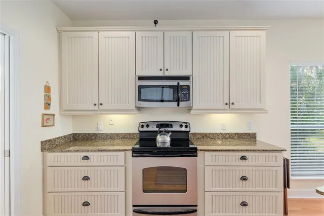 a view of a hallway with wooden floor and closet