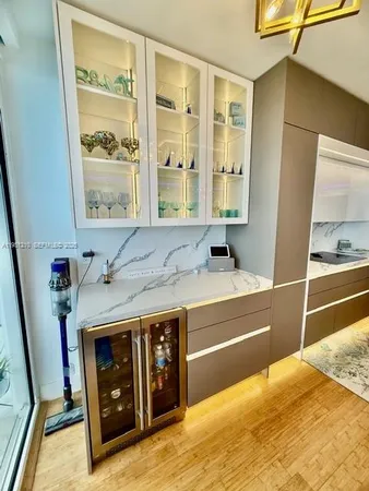 a large white kitchen with sink a refrigerator and a stove