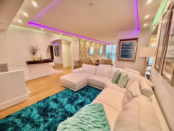 a bedroom with furniture and a flat screen tv