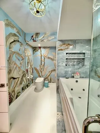 a spacious bathroom with a tub sink and mirror