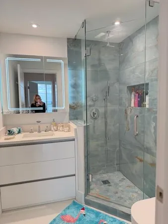 a bathroom with a tub and a large mirror