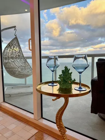 a living room with lots of furniture and view of kitchen