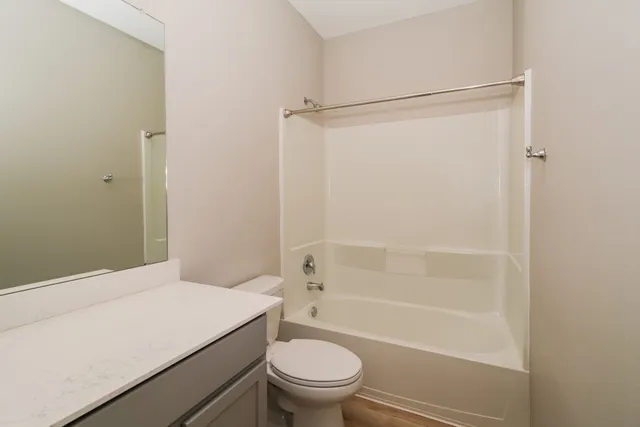 a bathroom with a shower a toilet and a sink