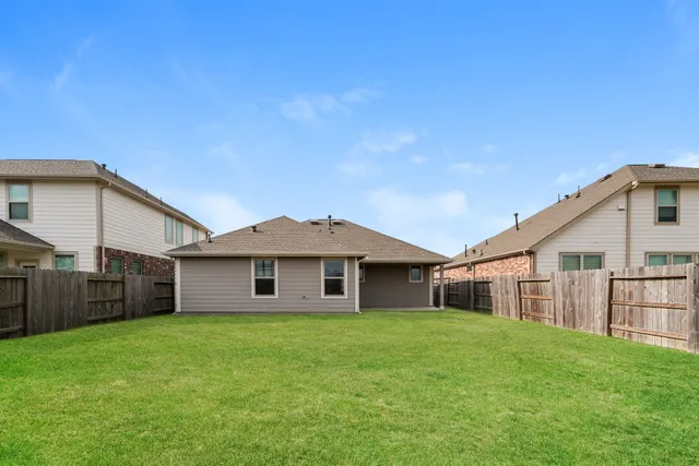 a view of a house with a yard and porch