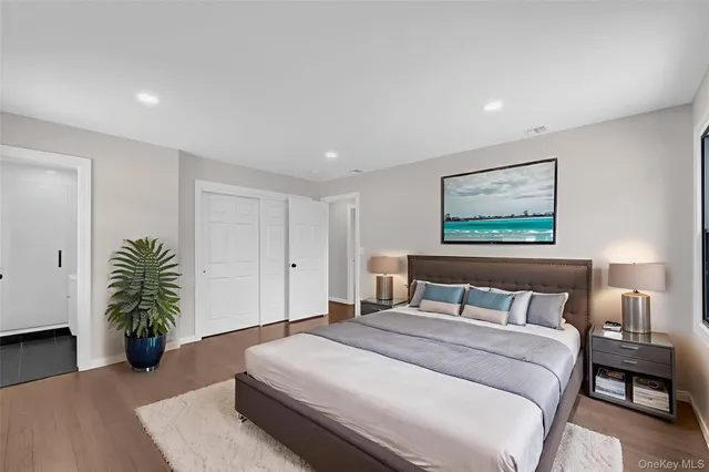 a bedroom with a bed and a potted plant