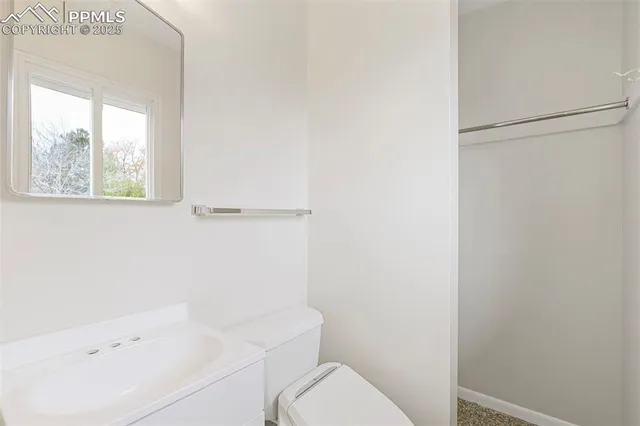 a white toilet sitting next to a bathroom sink