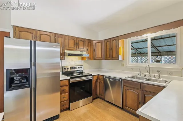 a kitchen with a sink appliances and cabinets