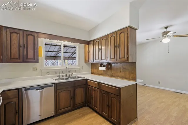 a kitchen with a sink cabinets and window