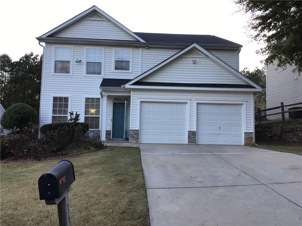 a front view of house with yard and trees