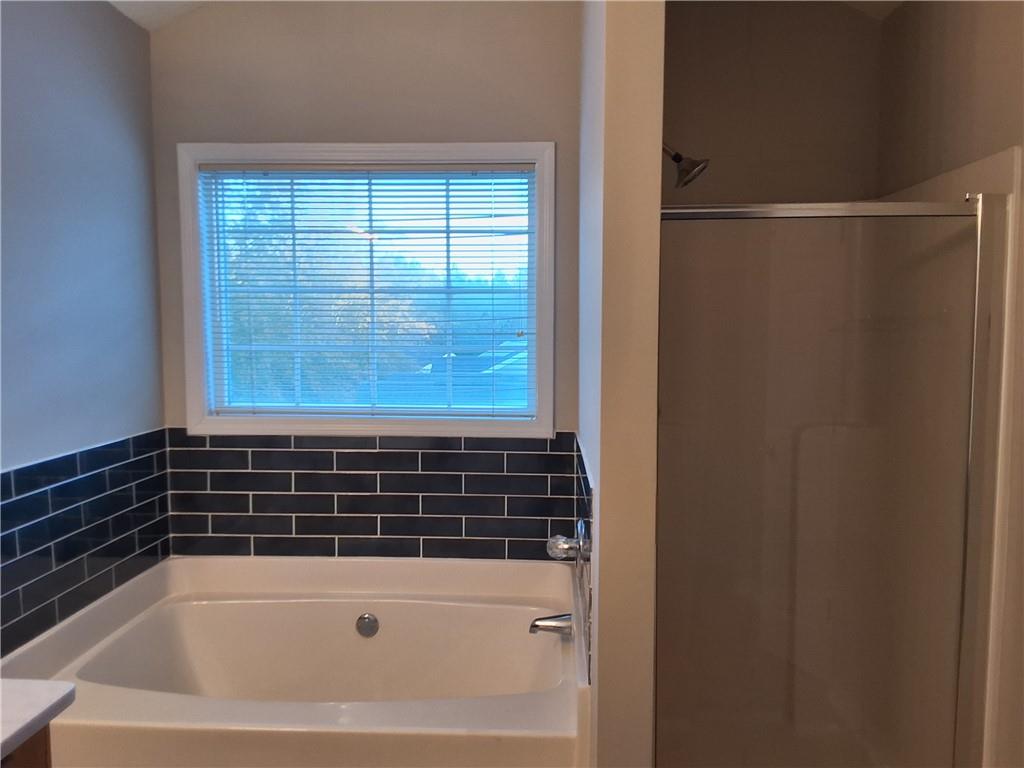 338 Alderman Trace Southwest Austell, GA 30168 - Photo 11 of 21 a bathroom with a bathtub