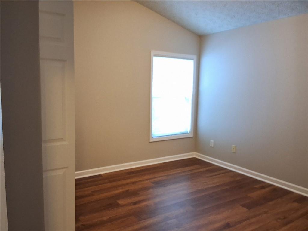 338 Alderman Trace Southwest Austell, GA 30168 - Photo 15 of 21 a view of an empty room with wooden floor and a window