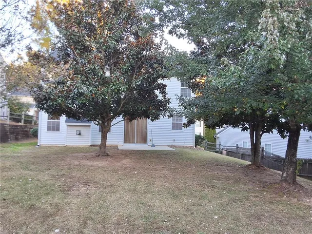 a white house that has a tree in front of it