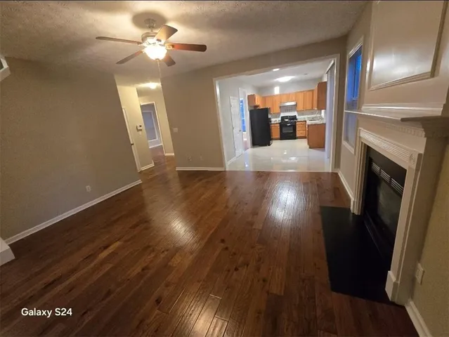 a view of a living room with wooden floor