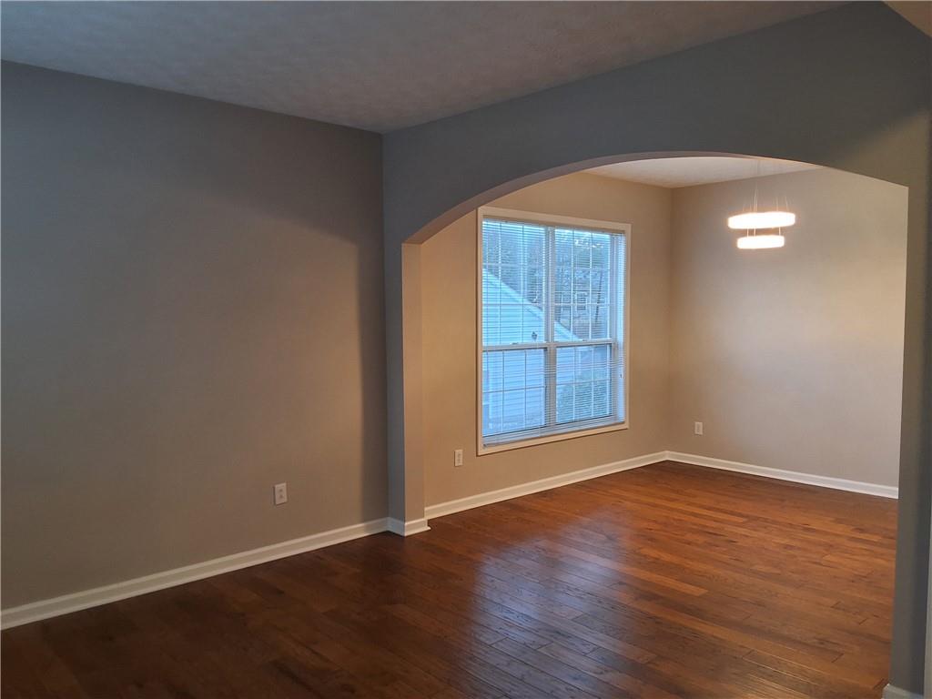 338 Alderman Trace Southwest Austell, GA 30168 - Photo 9 of 21 an empty room with wooden floor and windows