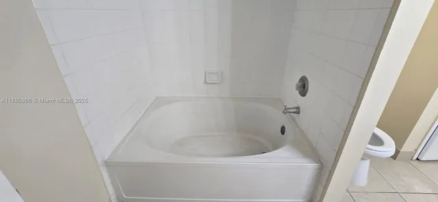 a bathroom with a sink and a glass door shower