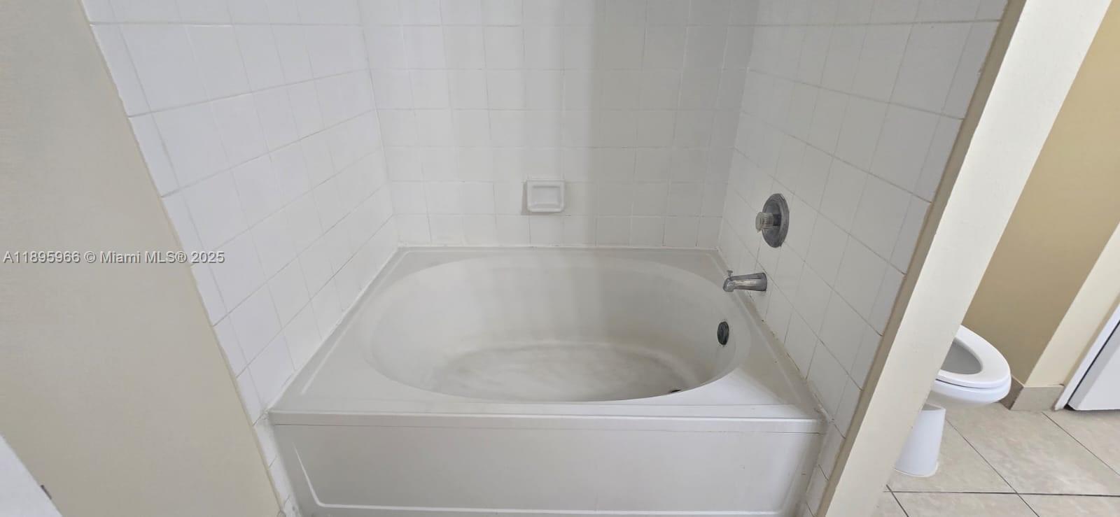 230 Southwest 117th Terrace, Unit 11208 Pembroke Pines, FL 33025 - Photo 12 of 28 a close up of a bathtub