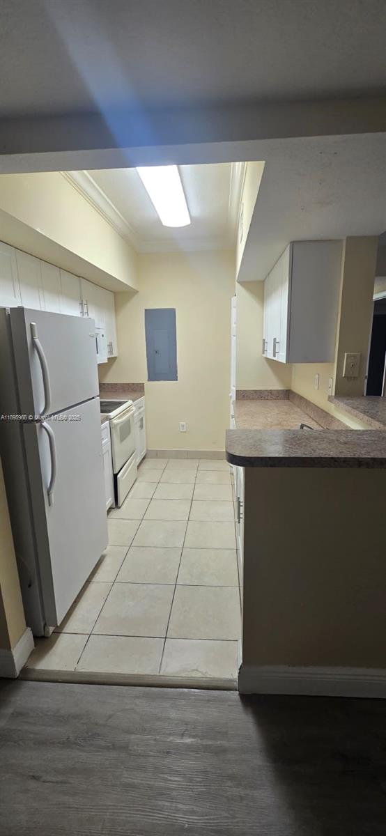 230 Southwest 117th Terrace, Unit 11208 Pembroke Pines, FL 33025 - Photo 14 of 28 a kitchen with a sink a refrigerator and cabinets