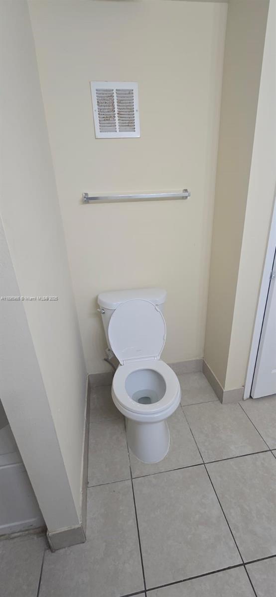 230 Southwest 117th Terrace, Unit 11208 Pembroke Pines, FL 33025 - Photo 15 of 28 a white toilet sitting next to a shower