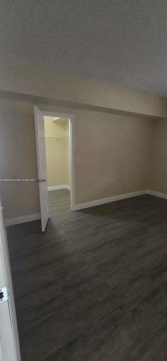 230 Southwest 117th Terrace, Unit 11208 Pembroke Pines, FL 33025 - Photo 17 of 28 an empty room with wooden floor and windows
