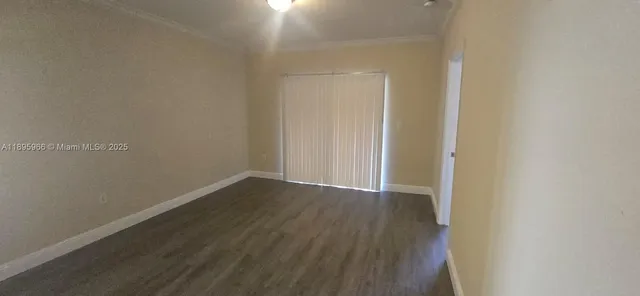 a view of kitchen with cabinets and wooden floor