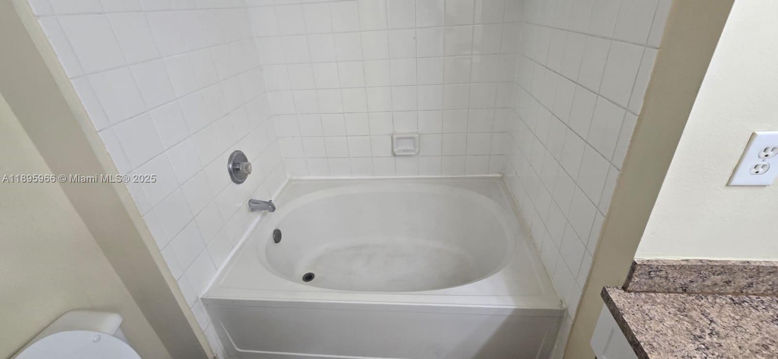 230 Southwest 117th Terrace, Unit 11208 Pembroke Pines, FL 33025 - Photo 9 of 28 a bathroom with a bathtub