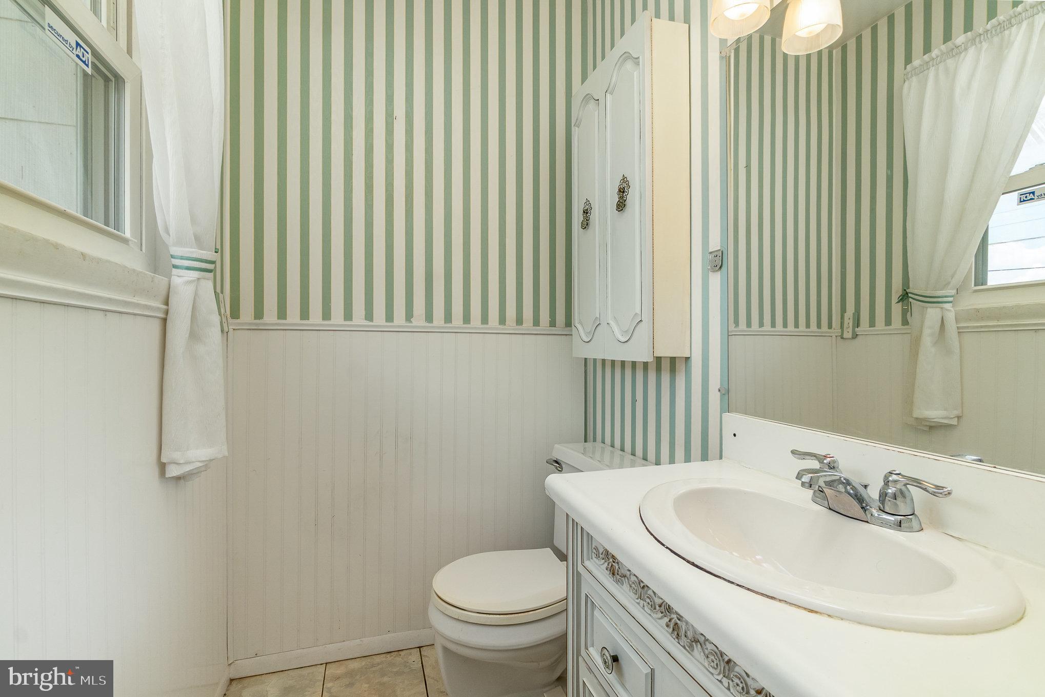 1908 Juniper Road Edgewood, MD 21040 - Photo 17 of 37 a bathroom with a toilet a sink and a mirror