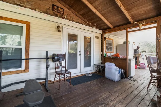 a view of a patio with table and chairs potted plants with wooden floor