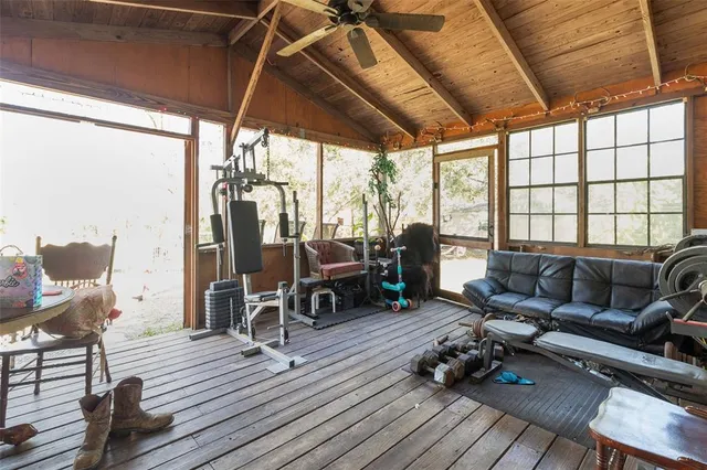 a work room with furniture wooden floor and windows