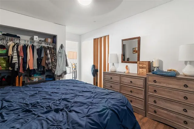 a bedroom with a large bed and a closet