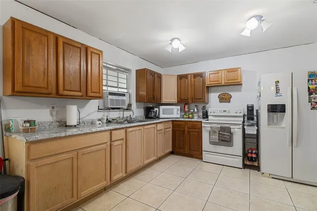 a kitchen with granite countertop cabinets stainless steel appliances and a sink