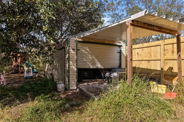 a view of a house with backyard and sitting area