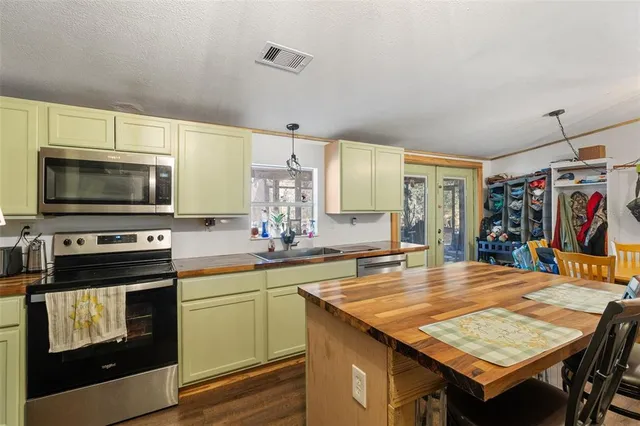 a kitchen with a stove a sink and a microwave