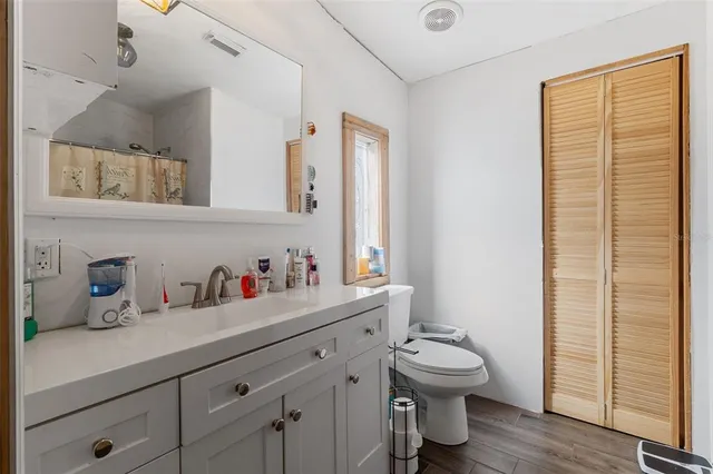 a bathroom with a toilet a sink and a window