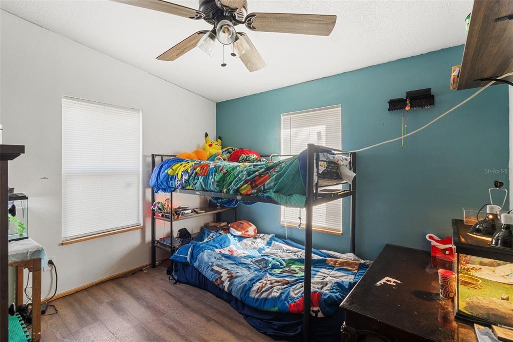 575 Bronco Road Zolfo Springs, FL 33890 - Photo 10 of 22 a bedroom with furniture a baby crib and a chandelier