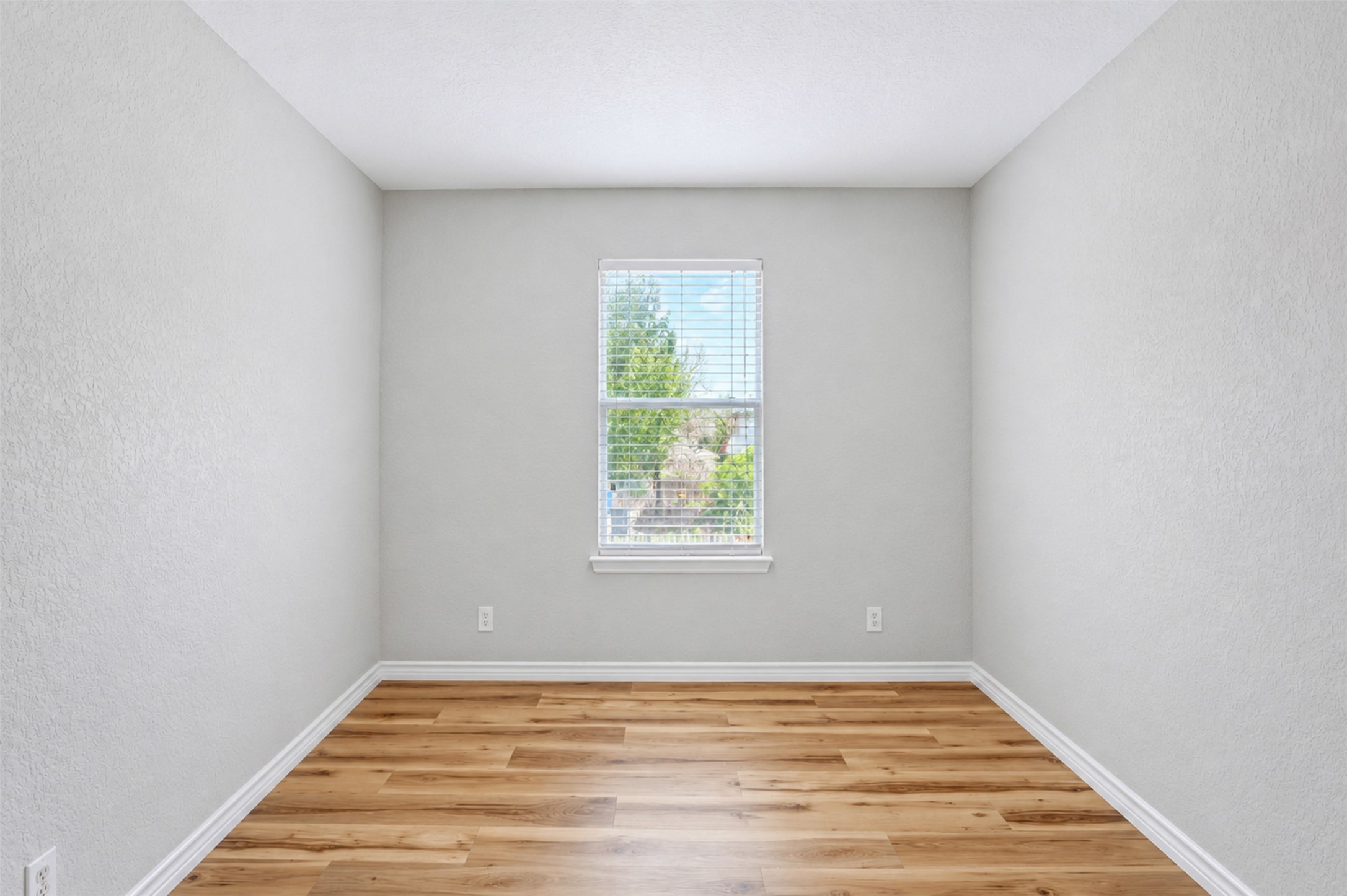 4523 Secure Lane Austin, TX 78725 - Photo 31 of 40 A well-lit room offers durable wood flooring and ample natural light through a single window.