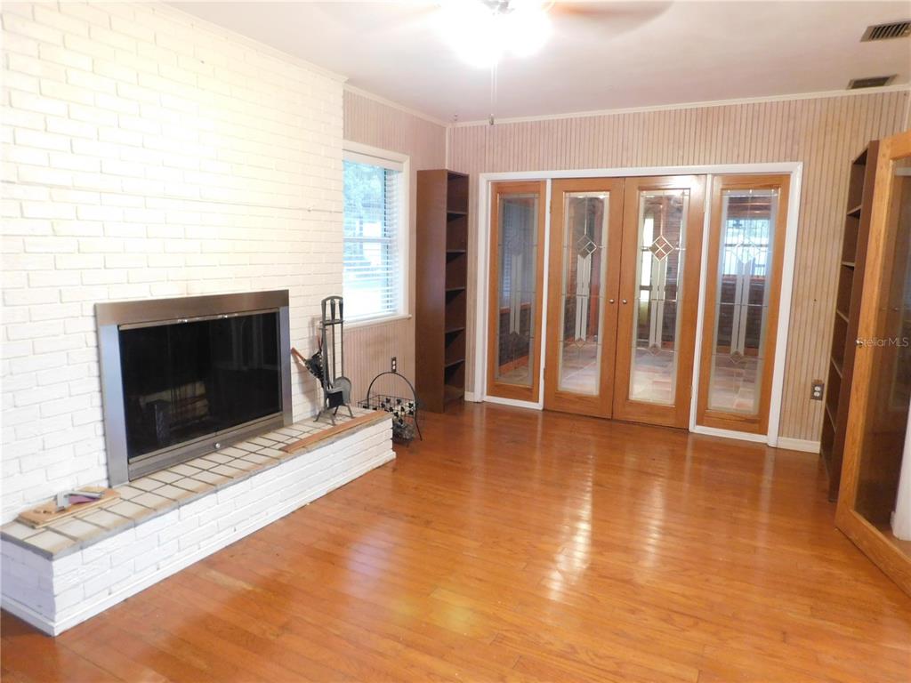 888 Forest Glen Road Clearwater, FL 33765 - Photo 18 of 61 a view of an empty room with glass door and fire place