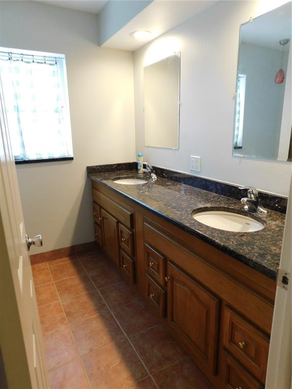888 Forest Glen Road Clearwater, FL 33765 - Photo 27 of 61 a bathroom with a granite countertop sink and a mirror