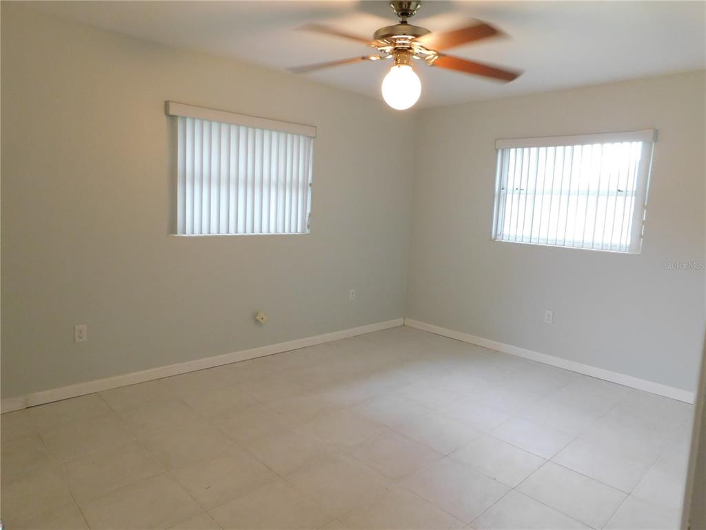 888 Forest Glen Road Clearwater, FL 33765 - Photo 30 of 61 an empty room with windows and fan