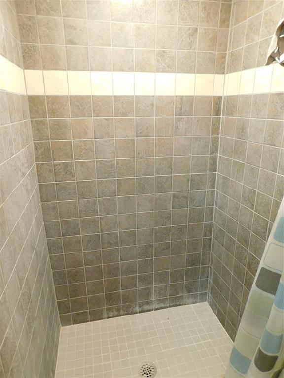 888 Forest Glen Road Clearwater, FL 33765 - Photo 34 of 61 a bathroom with a shower