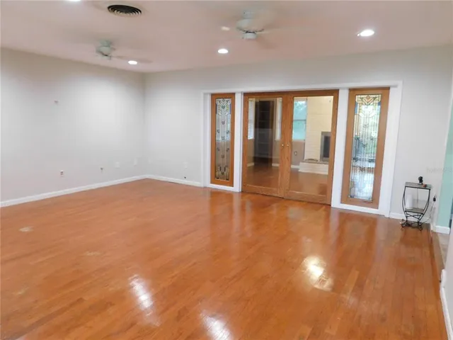 a kitchen with stainless steel appliances granite countertop a refrigerator a sink a stove a dining table and chairs