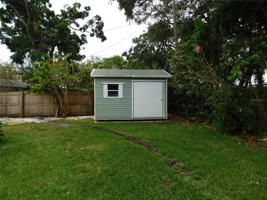 888 Forest Glen Road Clearwater, FL 33765 - Photo 48 of 61 a house with green field in front of it