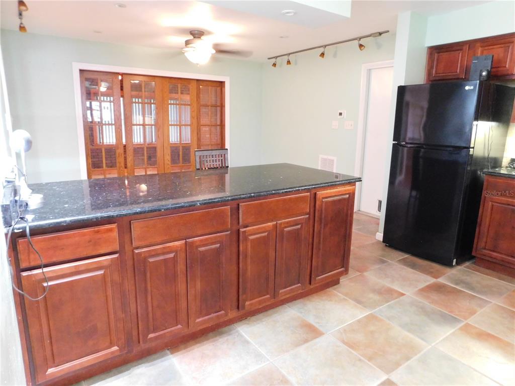 888 Forest Glen Road Clearwater, FL 33765 - Photo 10 of 61 a kitchen with stainless steel appliances granite countertop a refrigerator and a sink