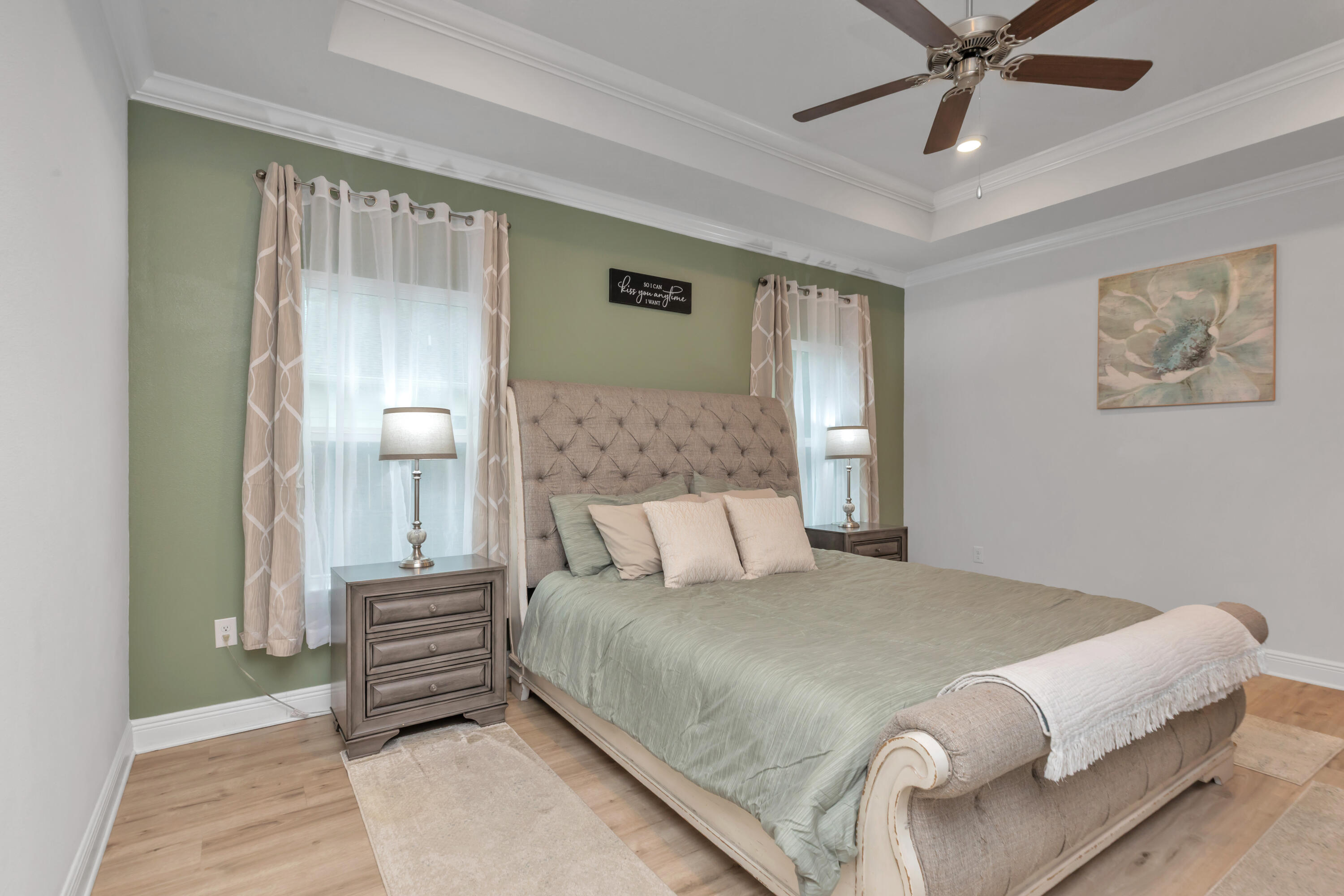 18 Hammock Circle Freeport, FL 32439 - Photo 21 of 50 a bedroom with a large bed and a chandelier