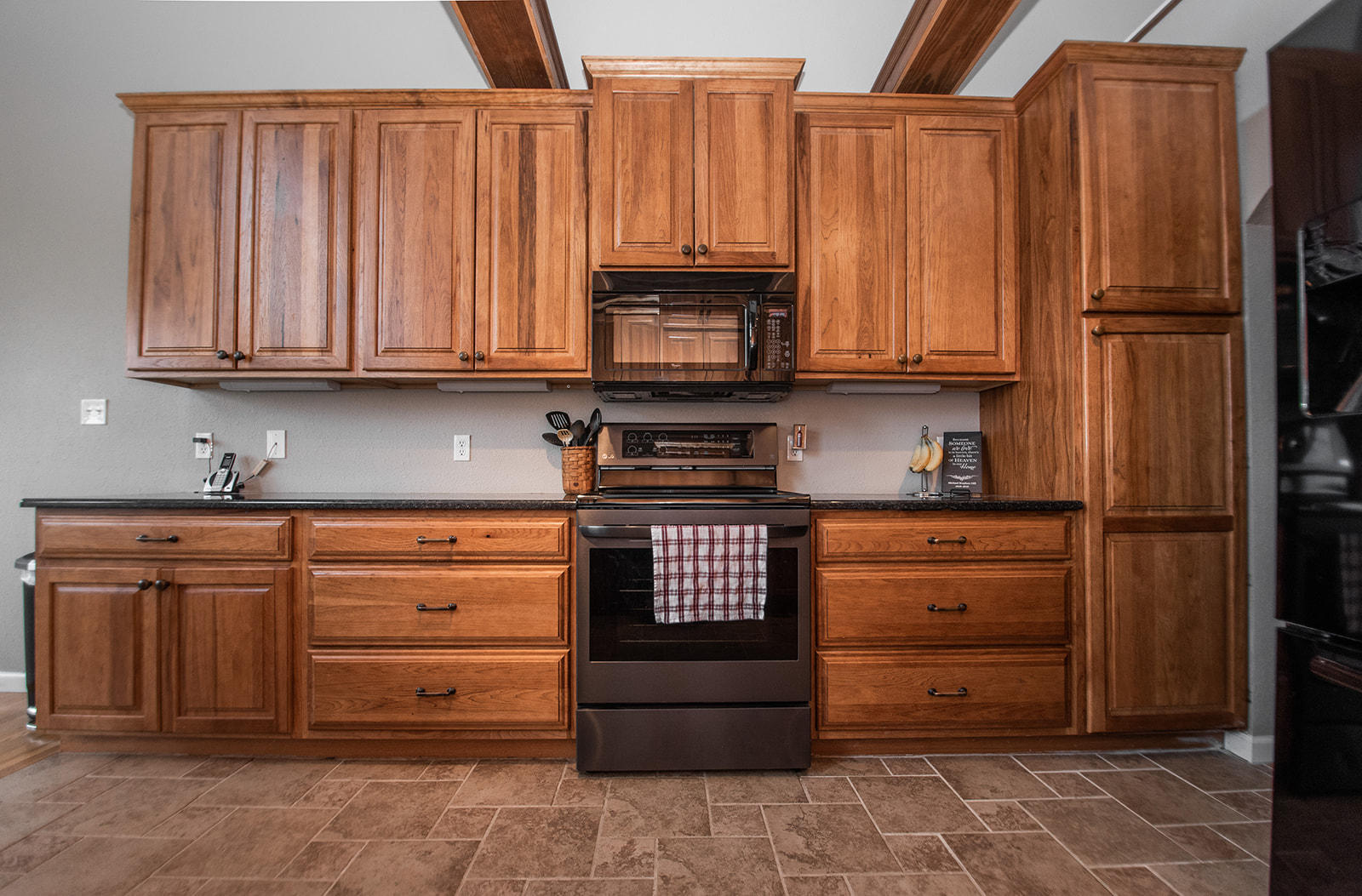 1056 Oyler Road Hardy, VA 24101 - Photo 16 of 45 a kitchen with granite countertop wooden cabinets and stainless steel appliances