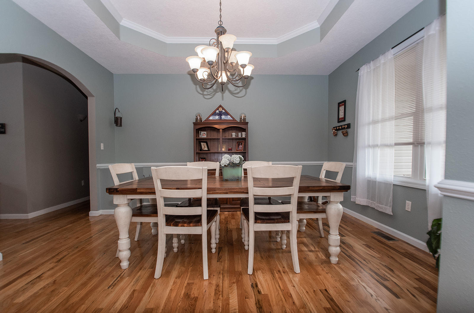 1056 Oyler Road Hardy, VA 24101 - Photo 19 of 45 a dining room with wooden floor a chandelier a wooden table and chairs