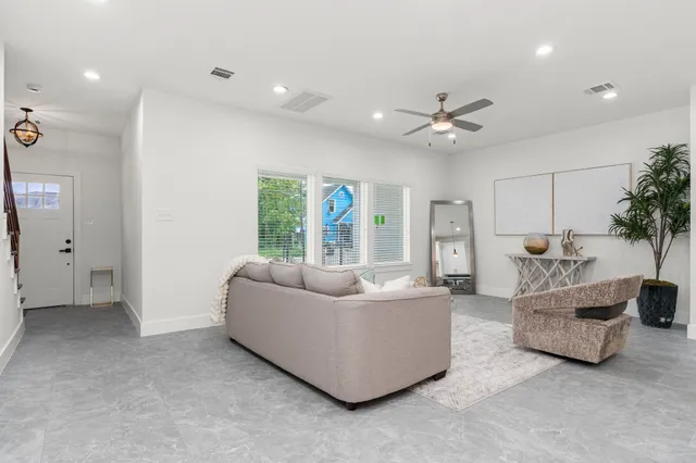 a living room with furniture and a large window